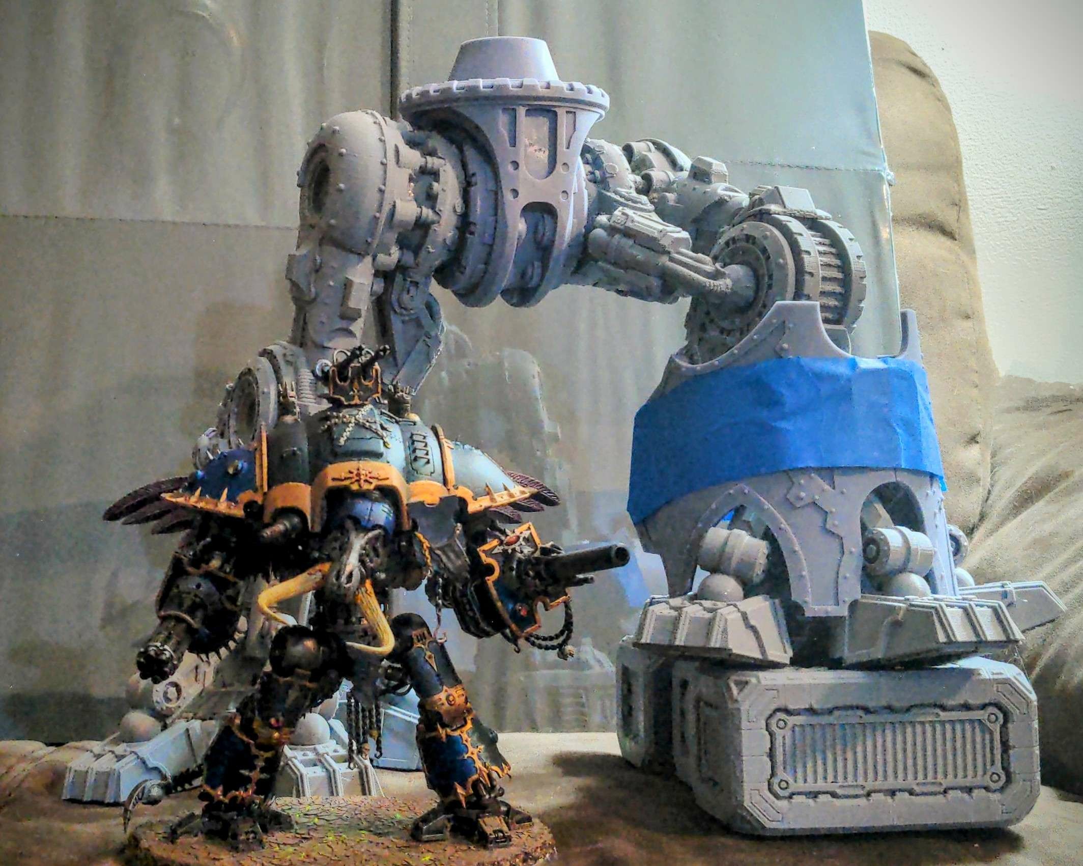 3d printed Warmaster Titan model with a Chaos Knight model in front of it for size comparison. The top of the Knight model barely comes up to the Titan's knee joint.